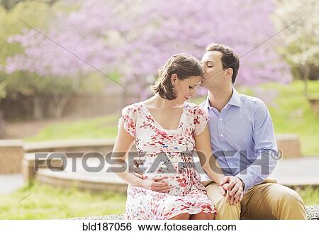 Pregnant Caucasian couple kissing outdoors View Large Photo Image Stock Photograph - Pregnant Caucasian couple kissing outdoors. Fotosearch