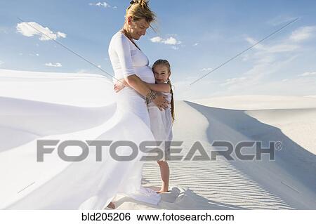 Pregnant Caucasian mother and daughter hugging in desert View Large Photo Image Stock Photograph - Pregnant Caucasian mother and daughter hugging in desert. Fotosearch