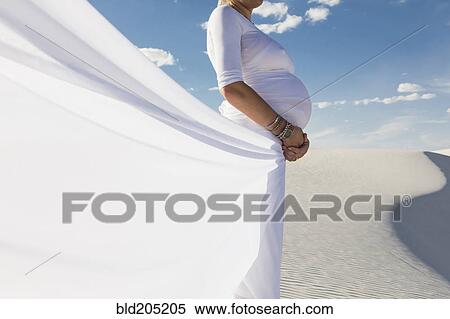 Stock Photography - Pregnant Caucasian woman in desert. Fotosearch