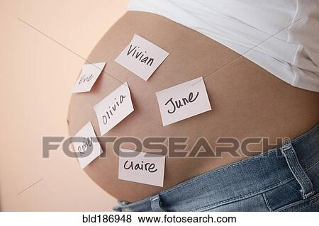 Pregnant Caucasian woman with name suggestions on belly View Large Photo Image Stock Photo - Pregnant Caucasian woman with name suggestions on belly. Fotosearch