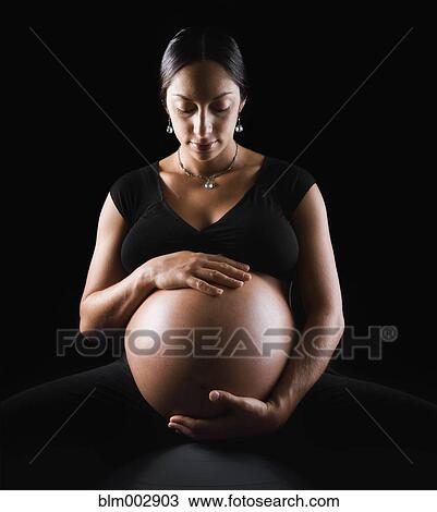 Pregnant Middle Eastern woman sitting on exercise ball View Large Photo Image Stock Image - Pregnant Middle Eastern woman sitting on exercise ball. Fotosearch