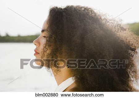 Profile of Hispanic woman standing near ocean View Large Photo Image Stock Image - Profile of Hispanic woman standing near ocean. Fotosearch