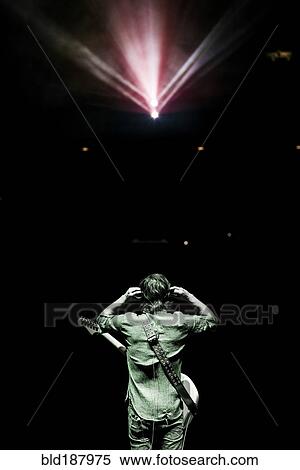 Stock Photography - Rear view of musician standing onstage. Fotosearch