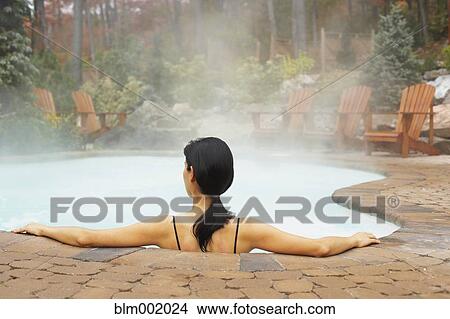 Rear view of woman sitting in hot tub View Large Photo Image Picture - Rear view of woman sitting in hot tub. Fotosearch