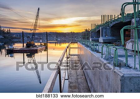 Reflection of bridge construction and sunset in still bay View Large Photo Image Stock Image - Reflection of bridge construction and sunset in still bay. Fotosearch