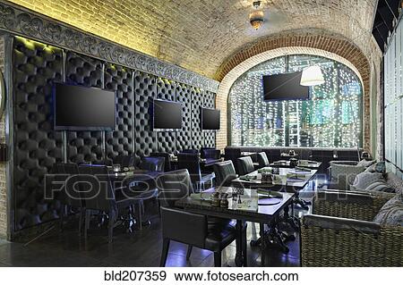 Stock Photo - Restaurant interior with TV screens on leather covered wall. Fotosearch