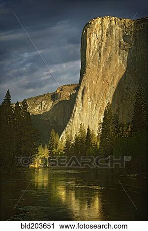 Stock Image - Rock formation reflected in still rural lake, Yosemite, CA, United States. Fotosearch
