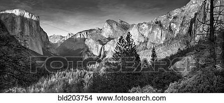 Rocky mountains overlooking rural valley, Yosemite, California, United States View Large Photo Image Picture - Rocky mountains overlooking rural valley, Yosemite, California, United States. Fotosearch