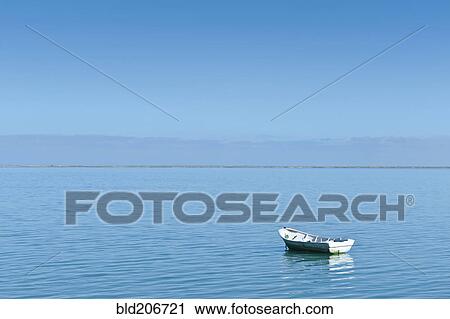 Stock Image - Rowing Boat Moored in Harbor. Fotosearch