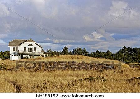 Stock Image - Rustic house in rural field. Fotosearch