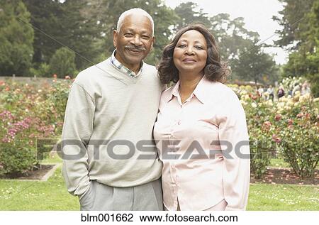 Stock Image - Senior African couple smiling outdoors. Fotosearch