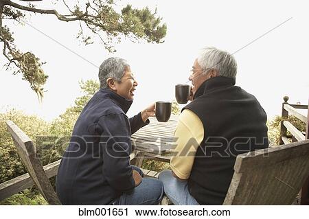 Senior Asian couple drinking coffee outdoors View Large Photo Image Stock Image - Senior Asian couple drinking coffee outdoors. Fotosearch