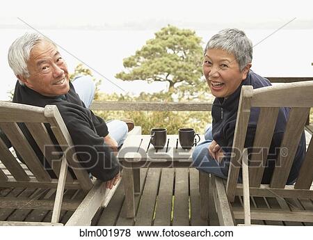 Stock Photo - Senior Asian couple smiling outdoors. Fotosearch