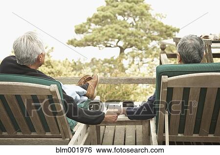 Stock Photograph - Senior couple holding hands outdoors. Fotosearch