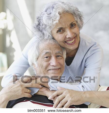 Stock Image - Senior Hispanic couple hugging. Fotosearch