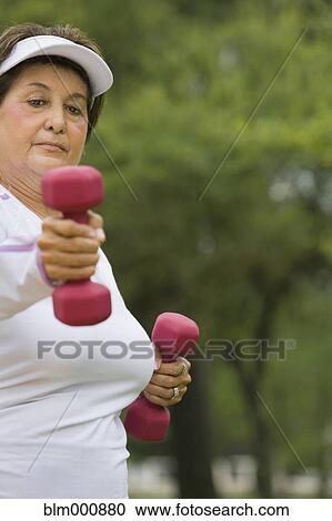 Senior Hispanic woman lifting hand weights View Large Photo Image Stock Image - Senior Hispanic woman lifting hand weights. Fotosearch