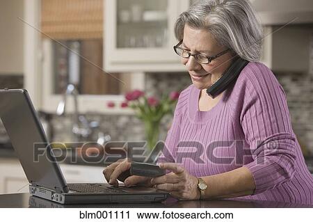 Senior Hispanic woman shopping online with credit card View Large Photo Image Stock Image - Senior Hispanic woman shopping online with credit card. Fotosearch