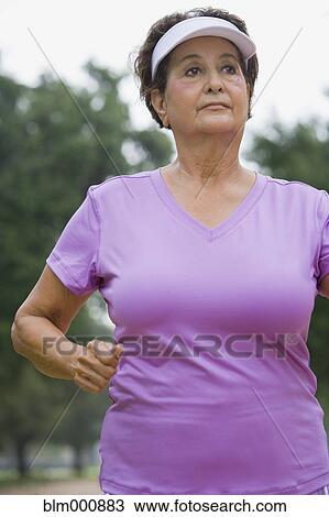 Stock Image - Senior Hispanic woman walking. Fotosearch