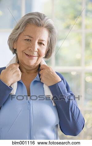 Senior Hispanic woman with towel after workout View Large Photo Image Stock Photograph - Senior Hispanic woman with towel after workout. Fotosearch