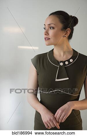 Picture - Serious businesswoman standing in office. Fotosearch