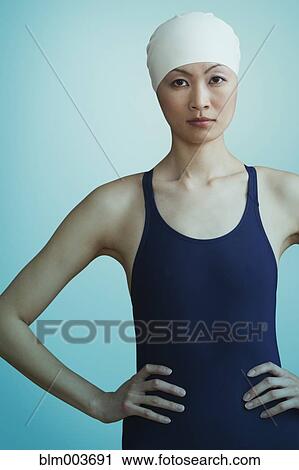 Stock Image - Serious Chinese woman in bathing suit and swimming cap. Fotosearch