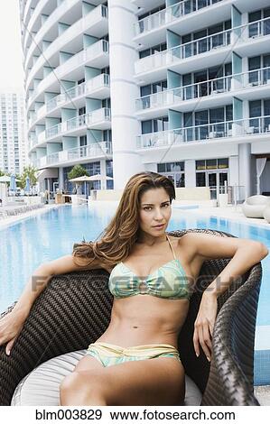 Stock Photo - Sexy Hispanic woman poolside in bikini. Fotosearch