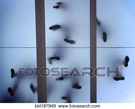 Stock Photo - Silhouette of feet standing on glass ceiling. Fotosearch