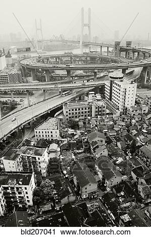 Stock Image - Slum Housing with Nanpu Bridge in Background. Fotosearch