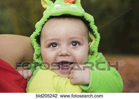 Stock Image - Smiling baby wearing costume. Fotosearch