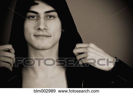 Stock Photo - Smiling mixed race man in hooded jacket. Fotosearch