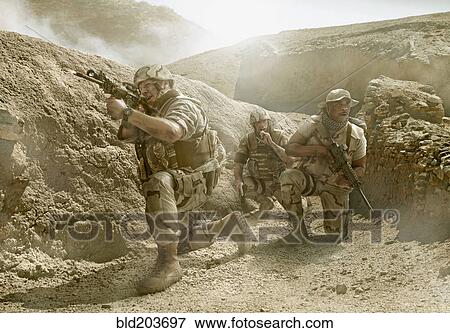 Stock Photo - Soldiers advancing in dry rural landscape. Fotosearch