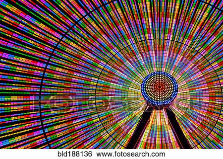Stock Photograph - Spinning ferris wheel illuminated at night. Fotosearch