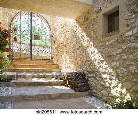 Stock Image - Stone wall and steps in garden. Fotosearch