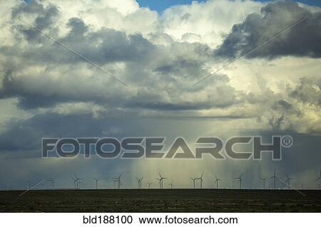 Storm clouds over wind turbines in rural landscape View Large Photo Image Stock Image - Storm clouds over wind turbines in rural landscape. Fotosearch
