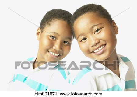 Studio shot of young African twin brothers smiling View Large Photo Image Stock Image - Studio shot of young African twin brothers smiling. Fotosearch
