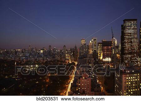 Stock Image - Sunset and illuminated cityscape, New York, New York, United States. Fotosearch