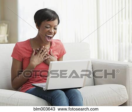 Surprised African woman using laptop View Large Photo Image Stock Image - Surprised African woman using laptop. Fotosearch