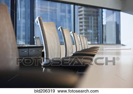 Stock Photo - Table and chairs in urban conference room. Fotosearch