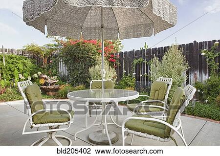 Stock Image - Table and chairs on patio. Fotosearch