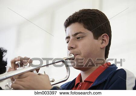 Teenage boy playing trumpet View Large Photo Image Stock Photo - Teenage boy playing trumpet. Fotosearch