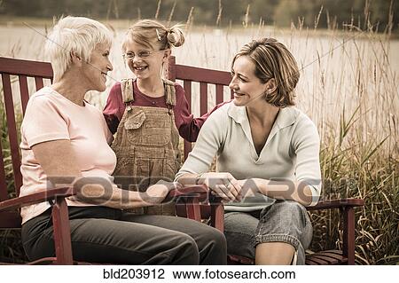 Stock Image - Three generations of Caucasian women smiling. Fotosearch