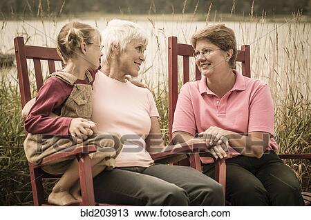 Stock Image - Three generations of Caucasian women smiling. Fotosearch