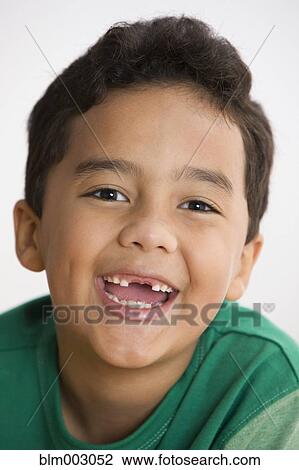 Stock Image - Toothless mixed race boy smiling. Fotosearch