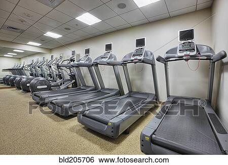 Treadmills in a row at gym View Large Photo Image Stock Photograph - Treadmills in a row at gym. Fotosearch
