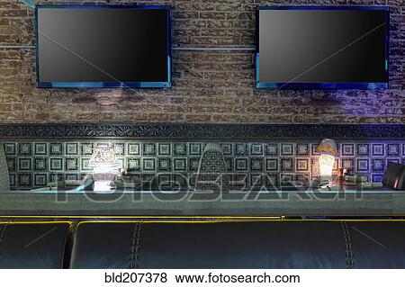 Stock Photo - TVs on brick wall in restaurant. Fotosearch