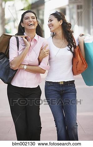 Two Hispanic women with shopping bags View Large Photo Image Stock Image - Two Hispanic women with shopping bags. Fotosearch