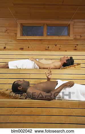 Two multi-ethnic men relaxing in sauna View Large Photo Image Stock Image - Two multi-ethnic men relaxing in sauna. Fotosearch
