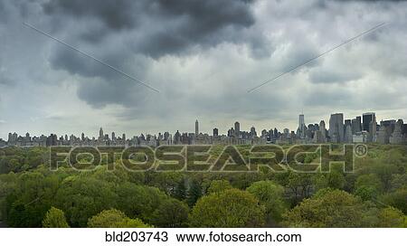 Stock Image - Urban park and city skyline, New York, New York, United States. Fotosearch