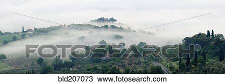 Stock Image - Valley Fog in the Val D'Orcia at Dawn. Fotosearch