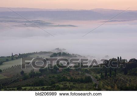 Stock Photo - Valley Fog in the Val D'Orcia at Dawn. Fotosearch